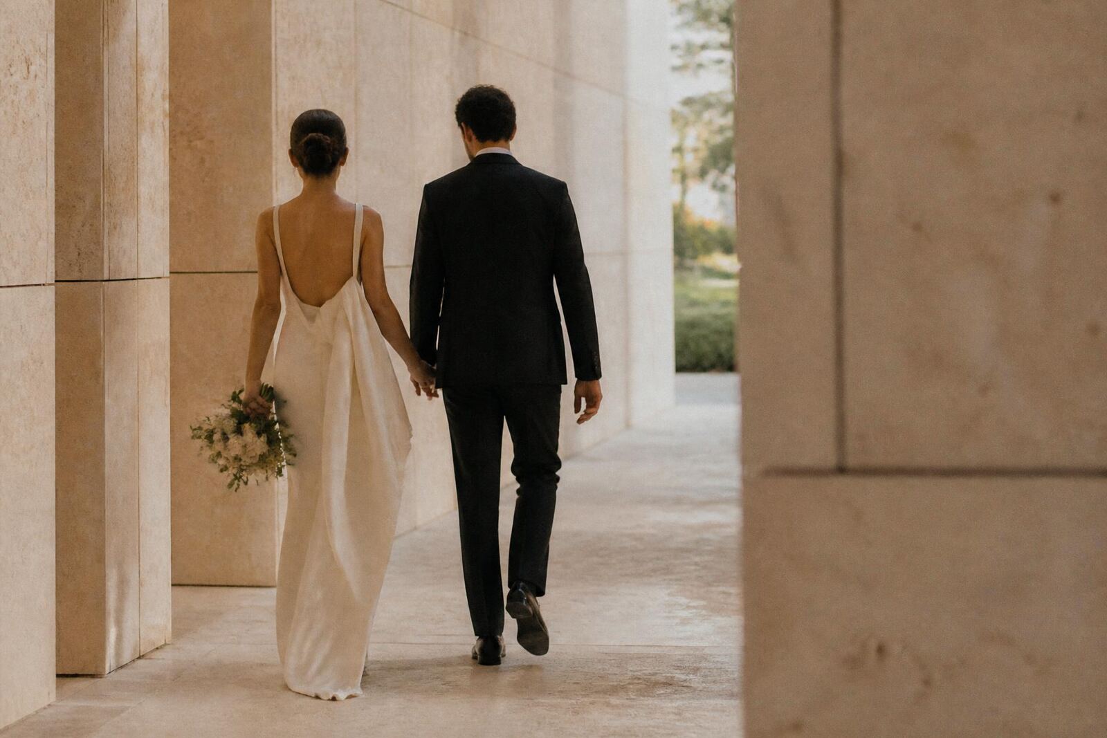 Couple beneath limestone arches at golden hour